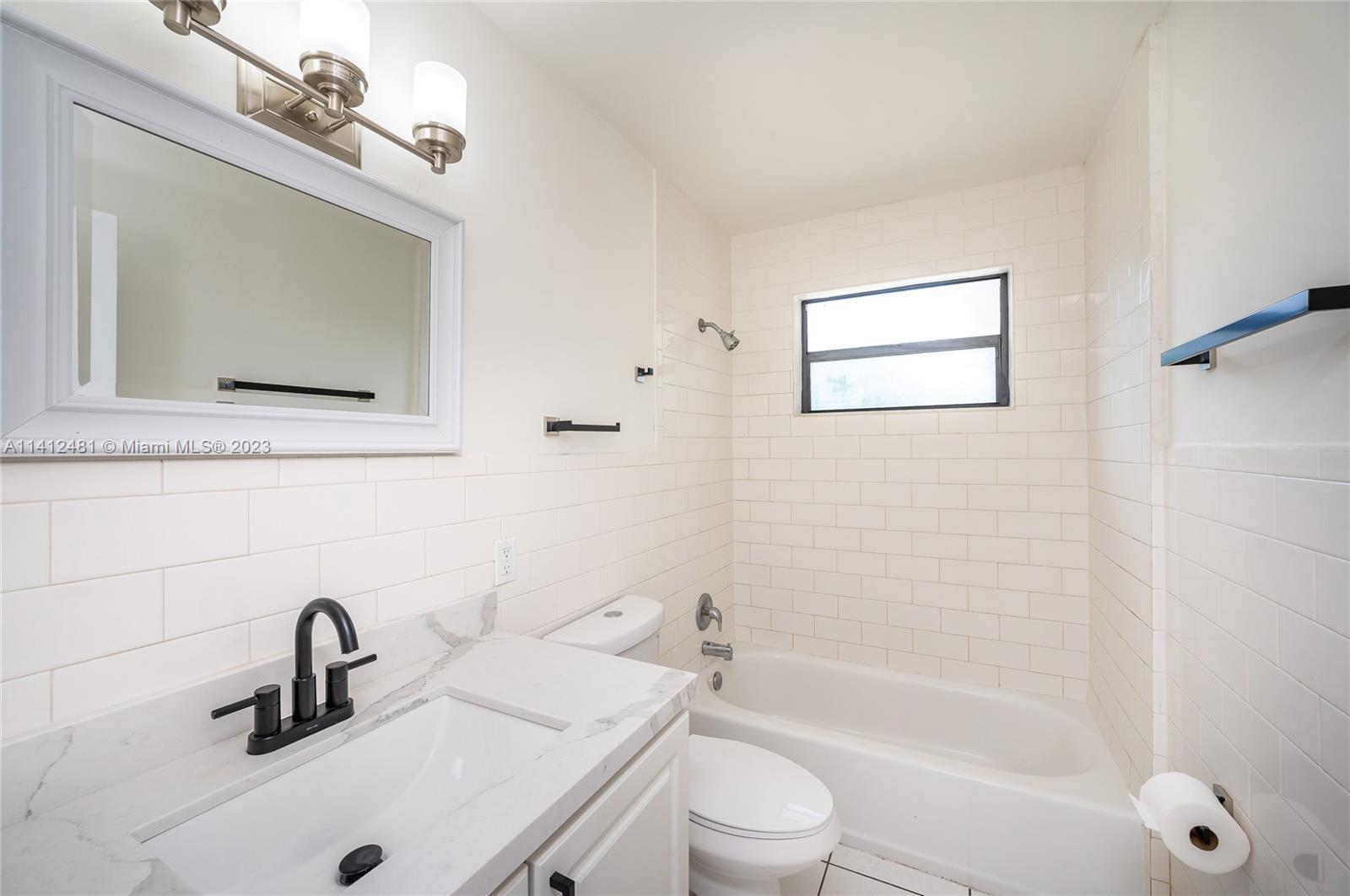 532 Northwest 15th Street Homestead, FL 33030 - Photo 22 of 32 a bathroom with a sink a toilet and a mirror