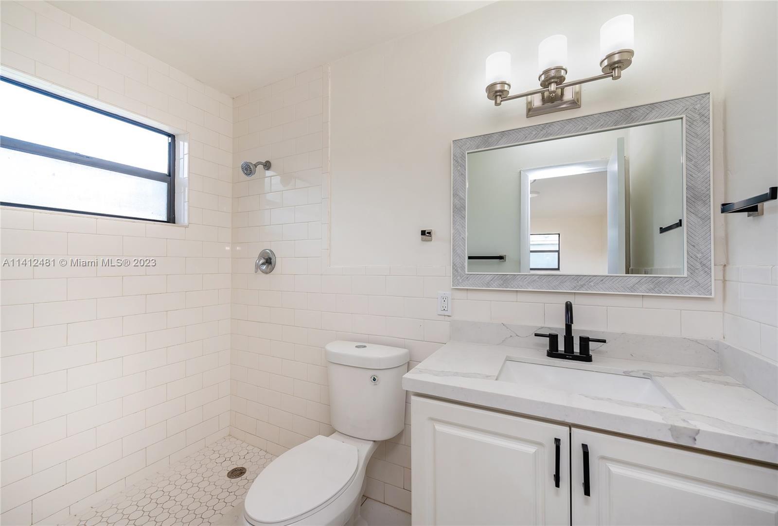 532 Northwest 15th Street Homestead, FL 33030 - Photo 30 of 32 a bathroom with a toilet sink and mirror