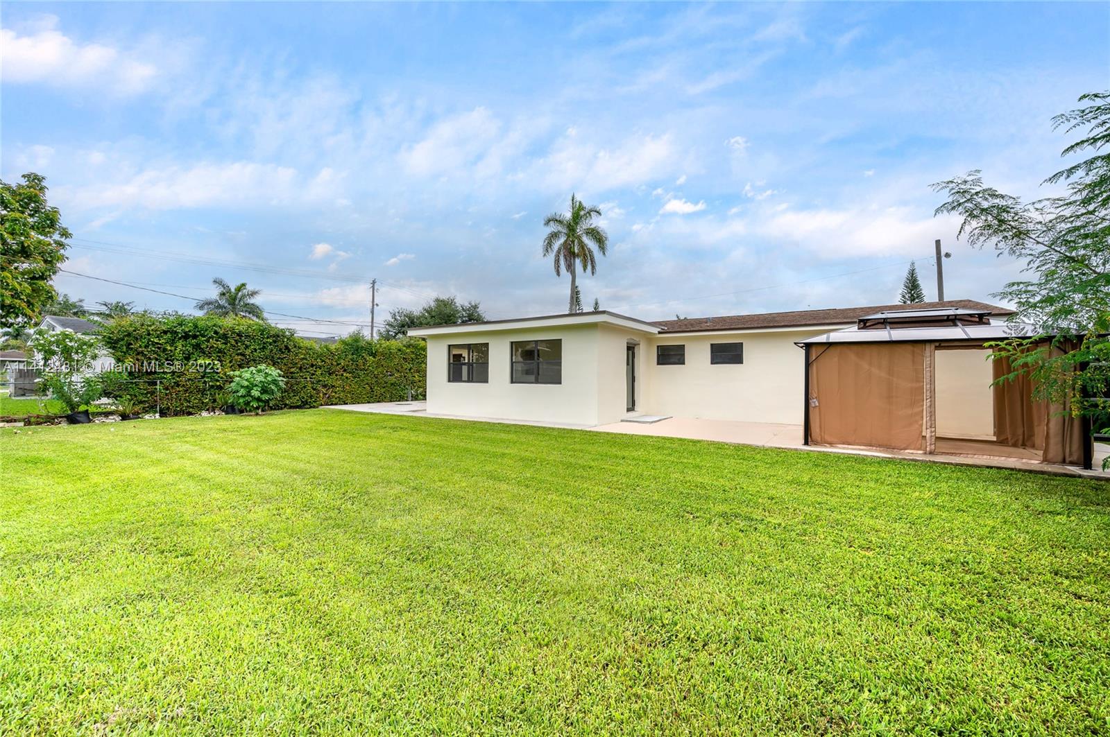 532 Northwest 15th Street Homestead, FL 33030 - Photo 6 of 32 a front view of a house with a garden