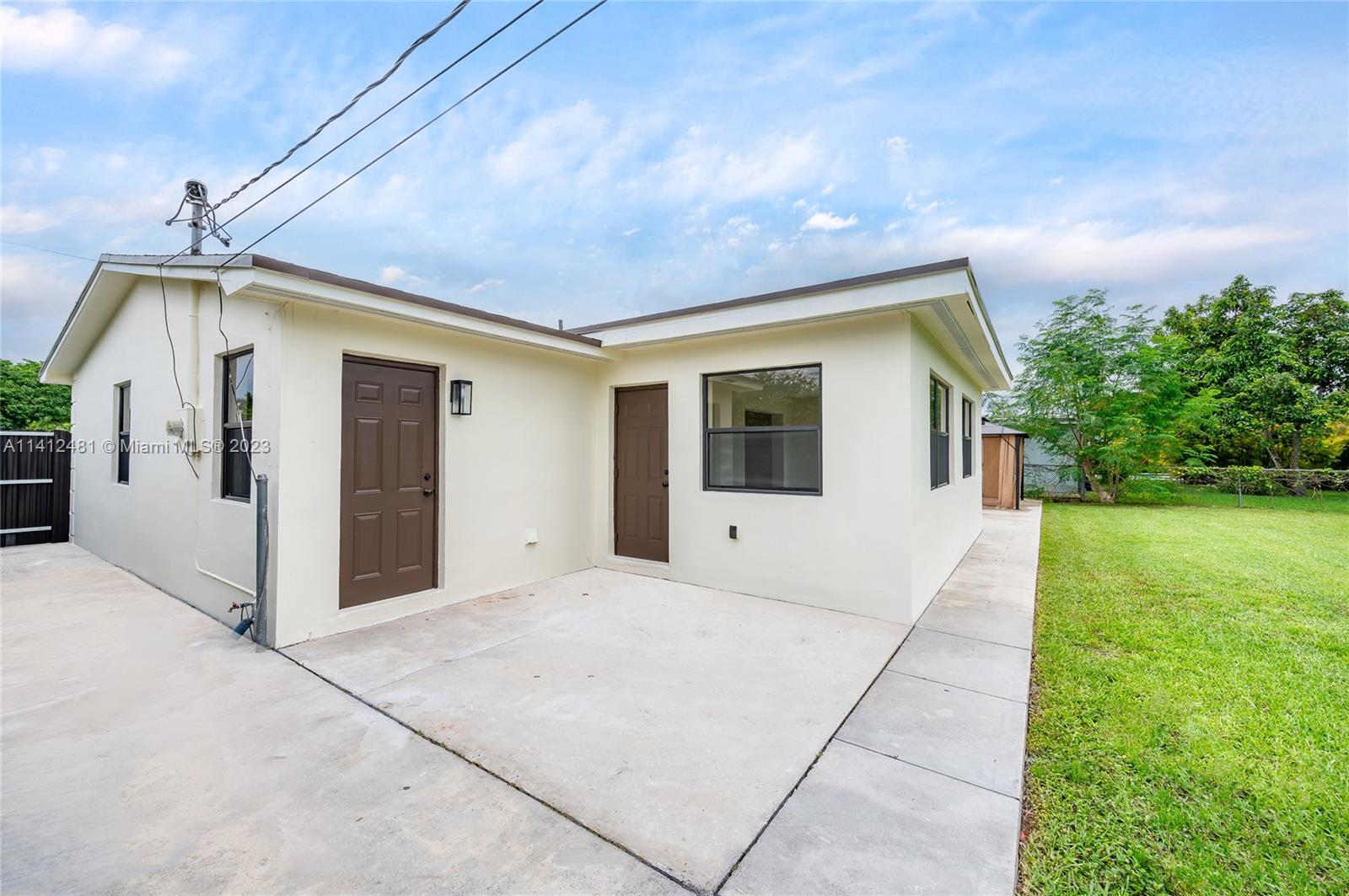 532 Northwest 15th Street Homestead, FL 33030 - Photo 7 of 32 a view of a white house with a yard