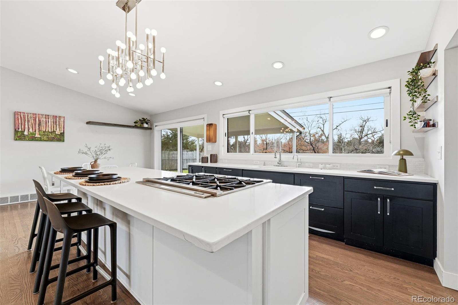 5320 Vale Drive Denver, CO 80246 - Photo 11 of 47 a kitchen with a stove a sink a dining table and chairs