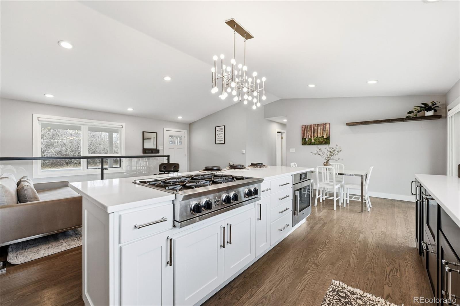 5320 Vale Drive Denver, CO 80246 - Photo 13 of 47 a kitchen that has a lot of white cabinets and wooden floor