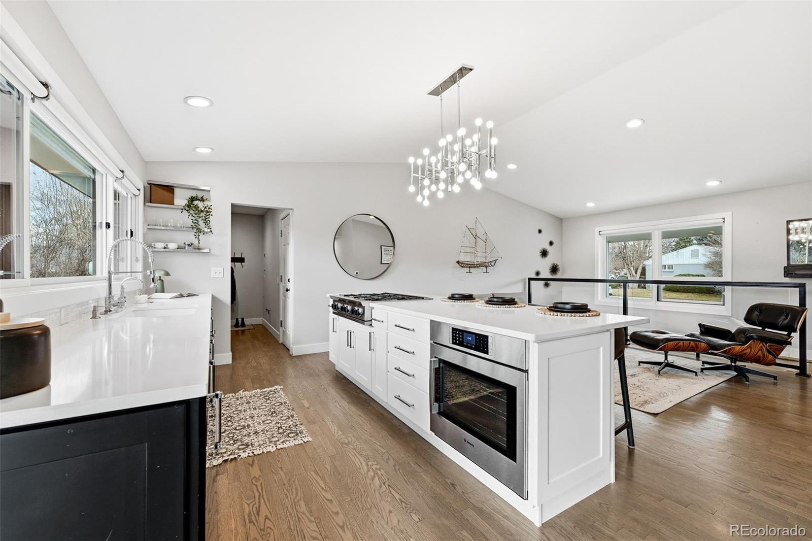 5320 Vale Drive Denver, CO 80246 - Photo 14 of 47 a open kitchen with stainless steel appliances a white stove top oven and couches with wooden floor