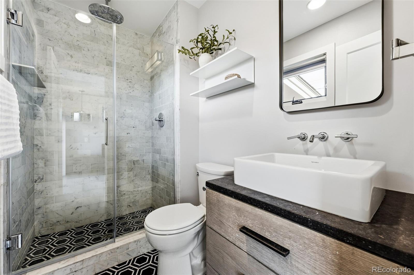 5320 Vale Drive Denver, CO 80246 - Photo 21 of 47 a bathroom with a sink a toilet and shower