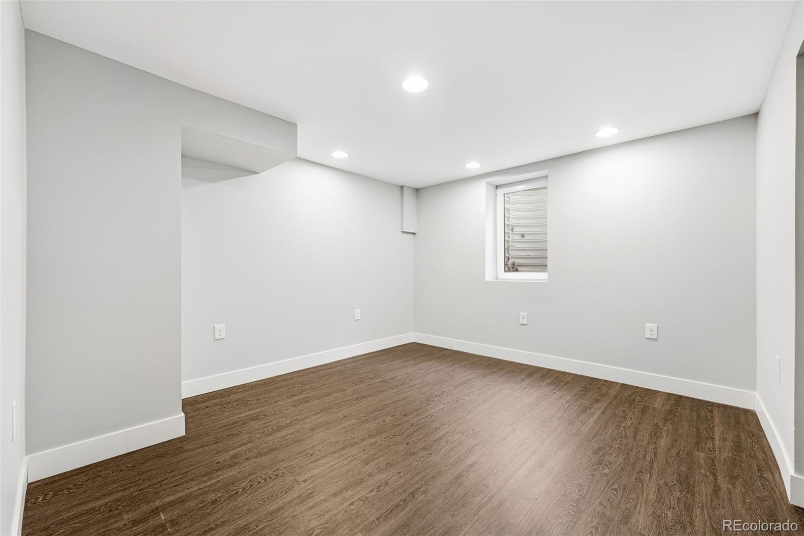5320 Vale Drive Denver, CO 80246 - Photo 31 of 47 a view of an empty room with wooden floor and a window