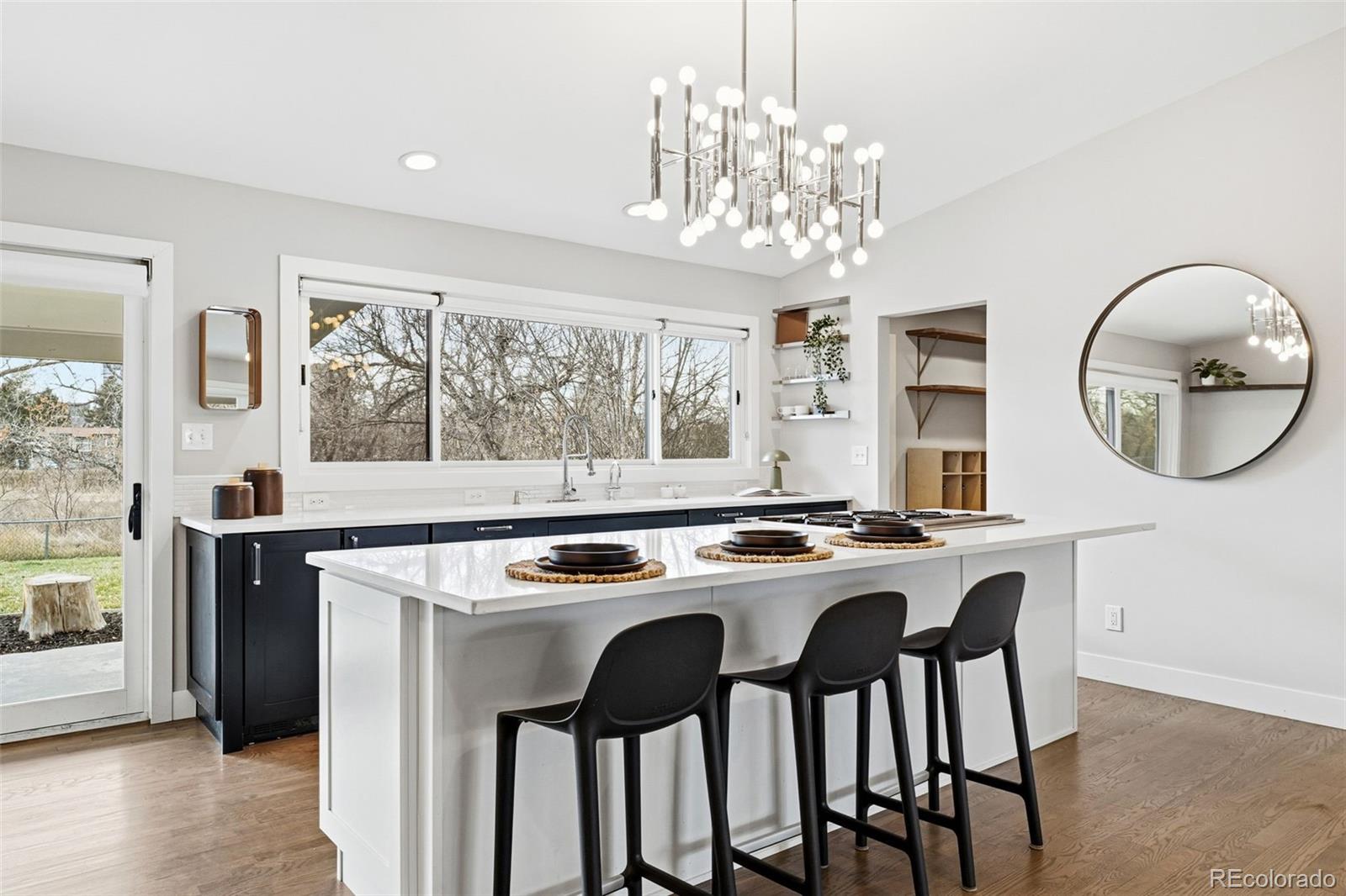 5320 Vale Drive Denver, CO 80246 - Photo 9 of 47 a kitchen that has a stove a table and chairs in it