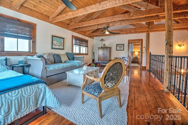 a living room with furniture a couch and large window