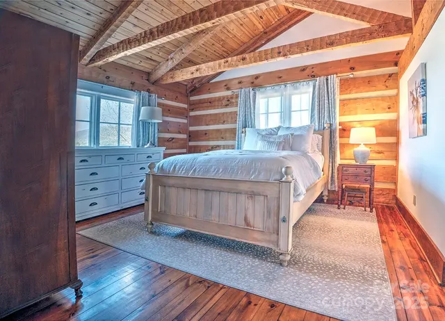 a bed sitting in a bedroom next to a window