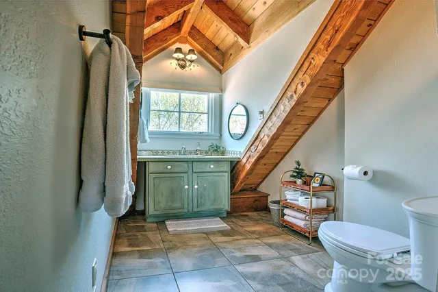 a bathroom with a toilet a sink and a mirror