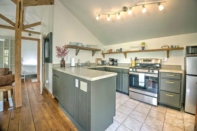 a bedroom with a bed and chair with a mirror