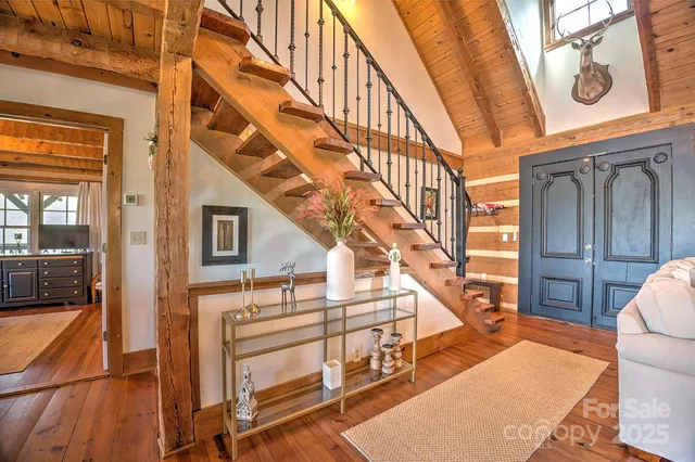 a view of entryway a livingroom with wooden floor and stairs