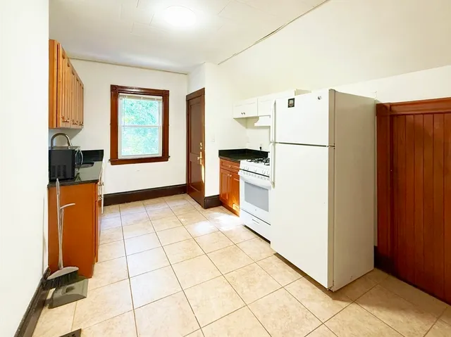 a kitchen with stainless steel appliances a refrigerator and a stove top oven