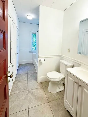 a bathroom with a toilet a sink and a mirror