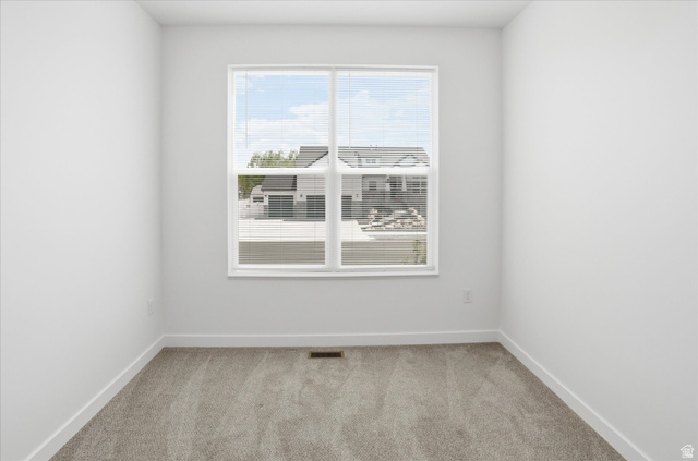 3636 West 910 South Syracuse, UT 84075 - Photo 28 of 70 Bright room featuring a large window with white blinds, neutral-toned carpet, and white baseboards