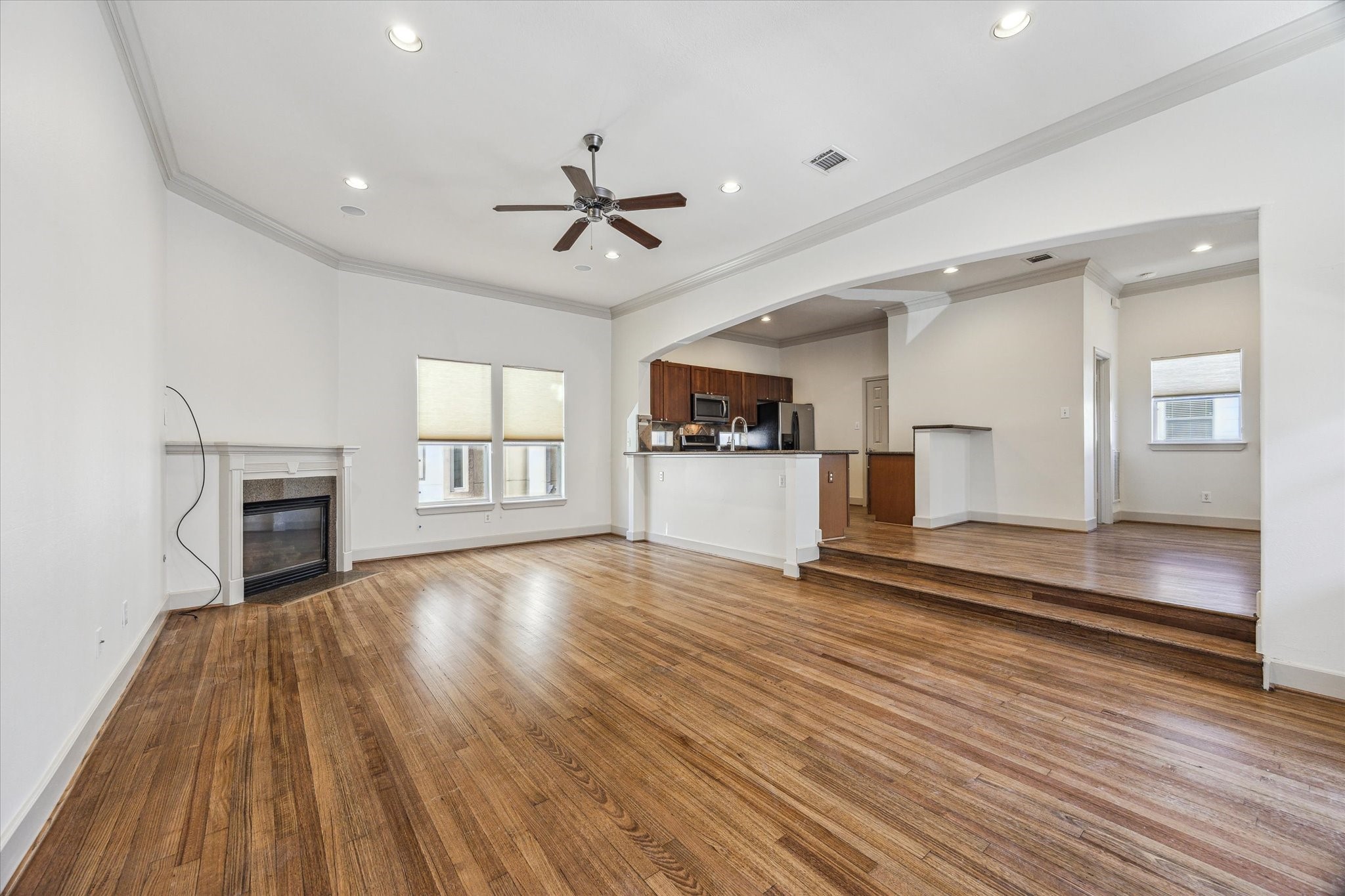 a view of empty room with wooden floor and window