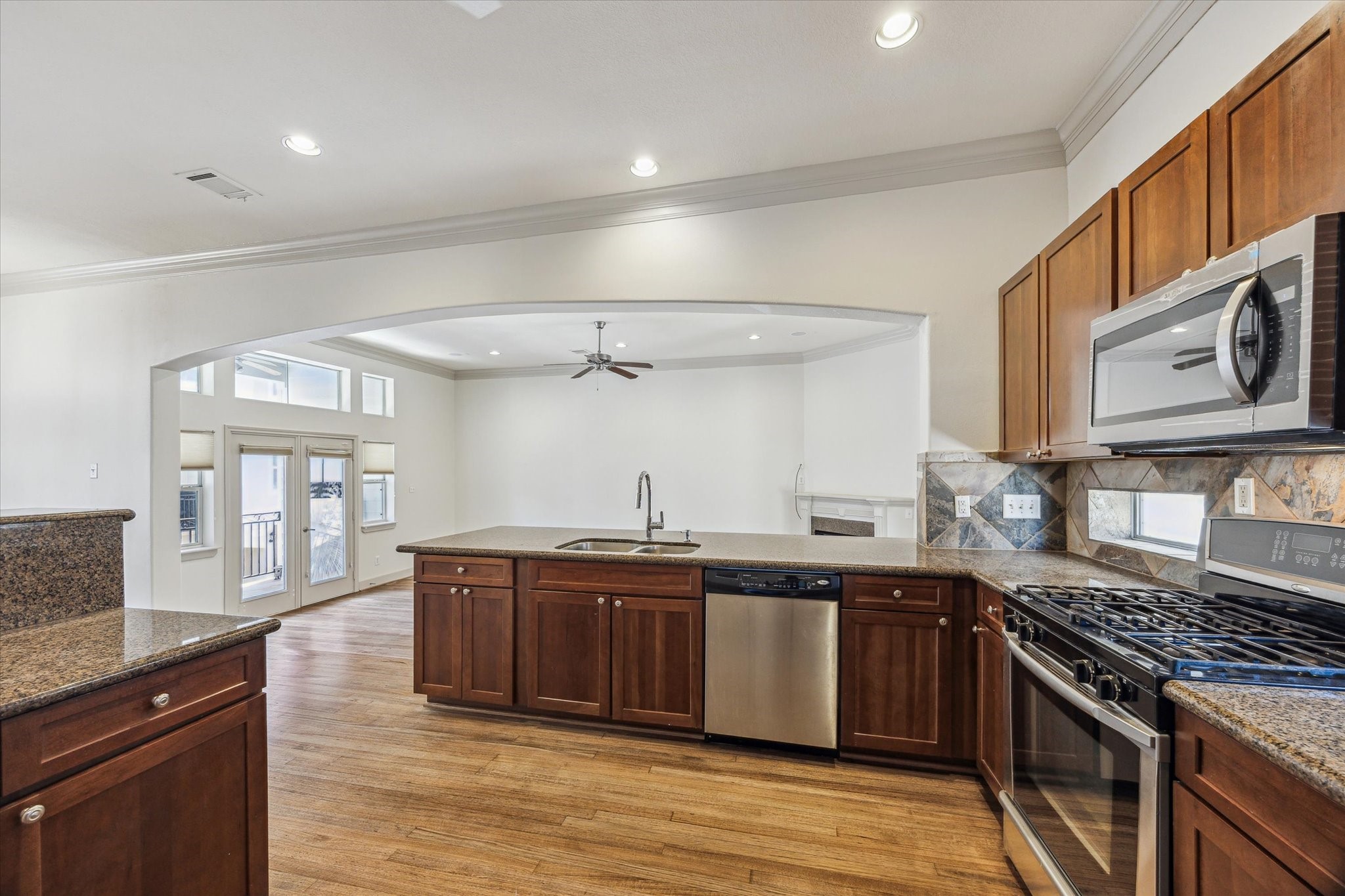 5334 Kiam Street, Unit C Houston, TX 77007 - Photo 11 of 23 a large kitchen with stainless steel appliances granite countertop a stove and a sink