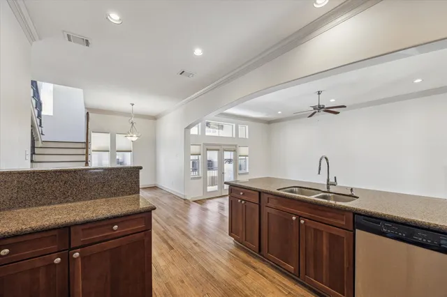 a kitchen with granite countertop a sink and cabinets