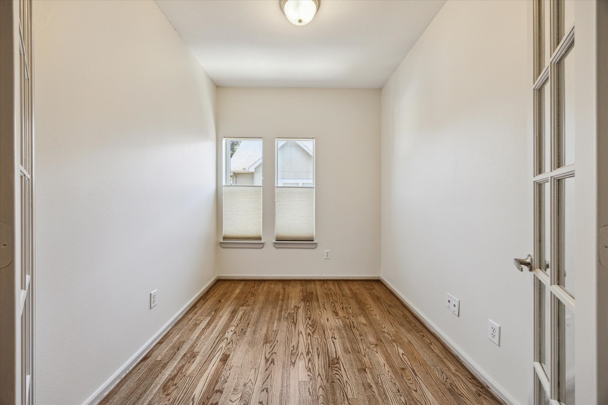 5334 Kiam Street, Unit C Houston, TX 77007 - Photo 18 of 23 an empty room with wooden floor and windows