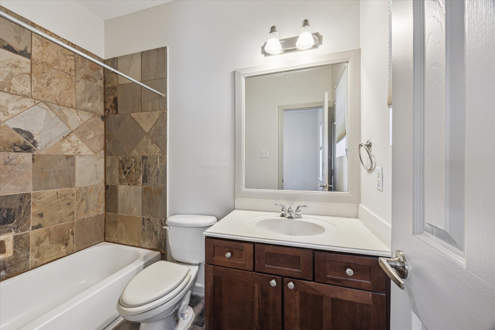 5334 Kiam Street, Unit C Houston, TX 77007 - Photo 20 of 23 a bathroom with a sink toilet a mirror and shower