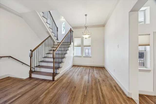 a view of entryway and hall with wooden floor