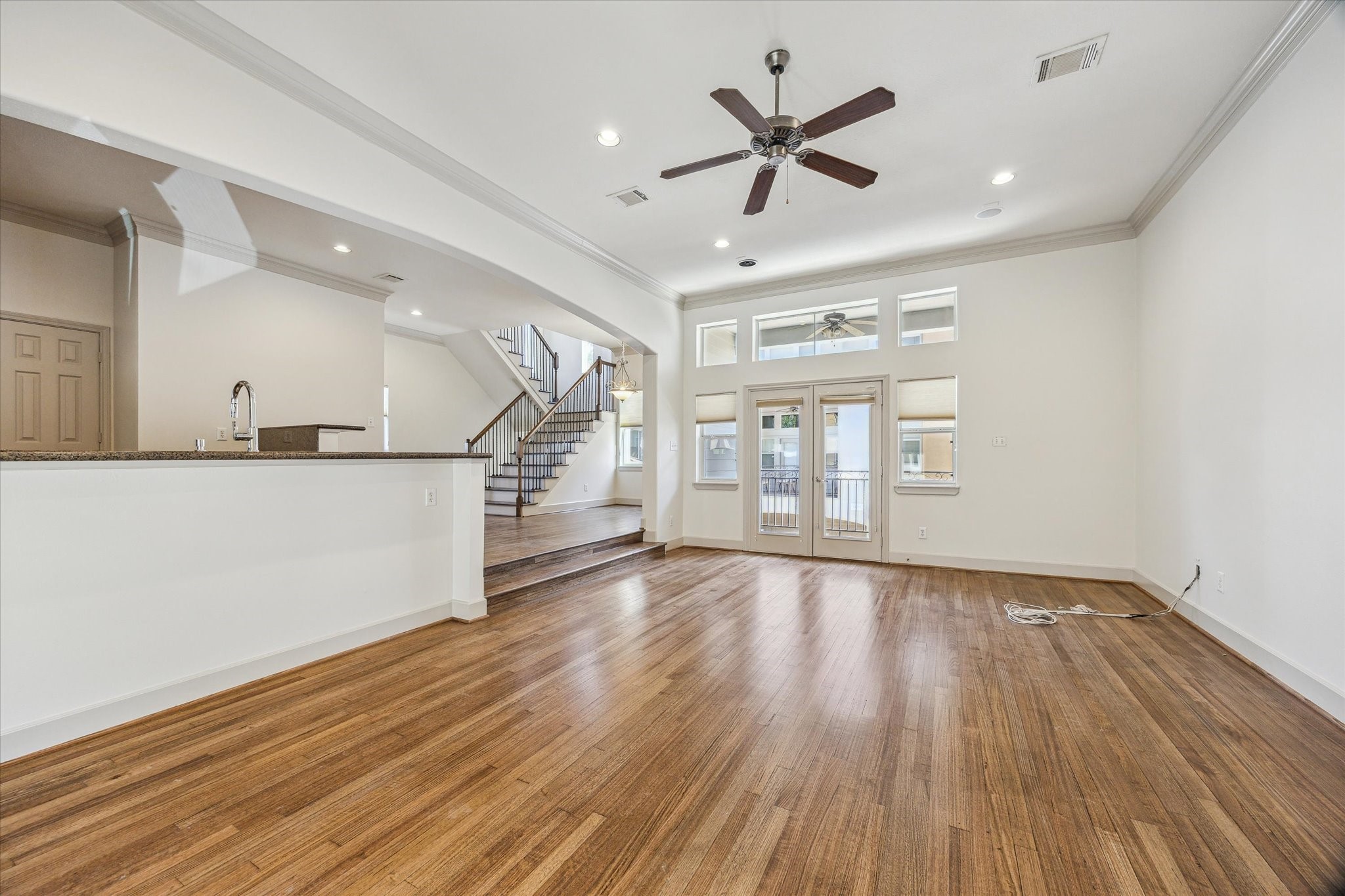 5334 Kiam Street, Unit C Houston, TX 77007 - Photo 7 of 23 a view of a livingroom with wooden floor a ceiling fan and windows
