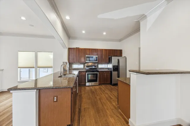 a kitchen with stainless steel appliances a refrigerator and a stove top oven