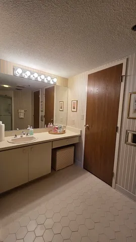 a large bathroom with a large tub and sink