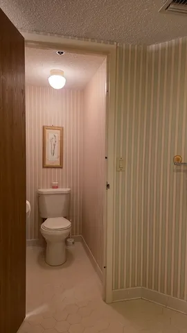 a bathroom with a toilet a sink and shower