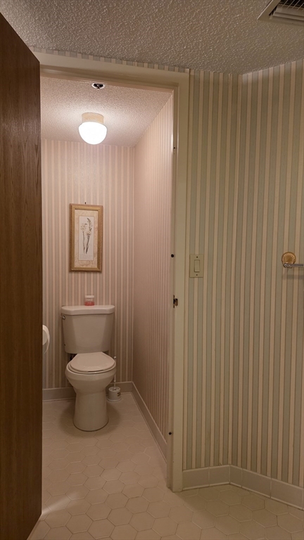 200 Burkhall Street, Unit 102 Weymouth, MA 02190 - Photo 15 of 25 a bathroom with a toilet a sink and shower
