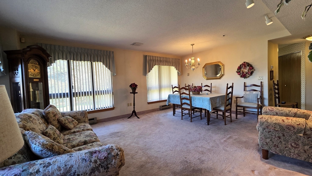 200 Burkhall Street, Unit 102 Weymouth, MA 02190 - Photo 3 of 25 a living room with furniture and a large window