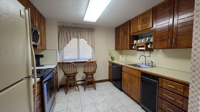 a kitchen with a sink cabinets and window