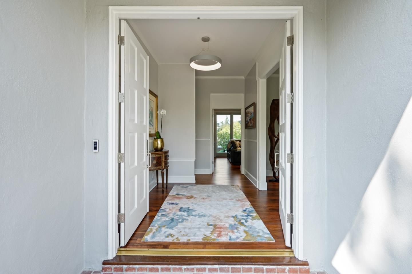 2312 Crest Lane Menlo Park, CA 94025 - Photo 5 of 34 a view of a hallway with wooden floor and a living room