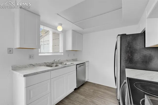 a kitchen with a sink stove and refrigerator