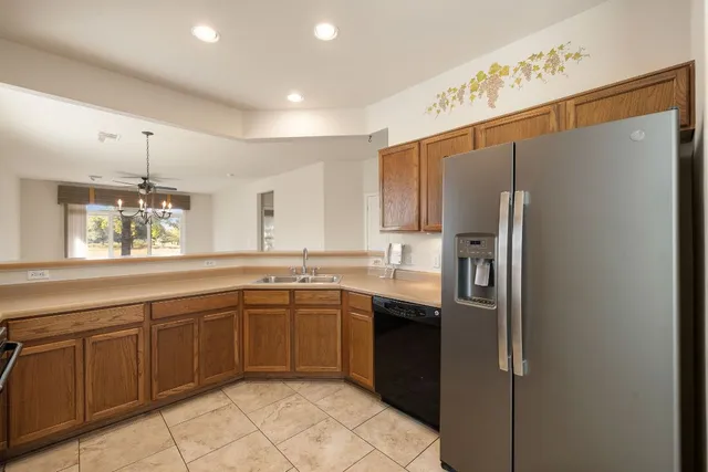 a kitchen with stainless steel appliances granite countertop a refrigerator and a sink