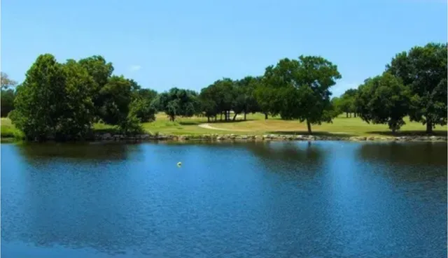 a view of a lake with houses in the back