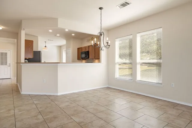 a view of a kitchen with a dishwasher and a refrigerator