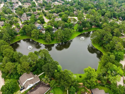 an aerial view of a house with a yard and lake view