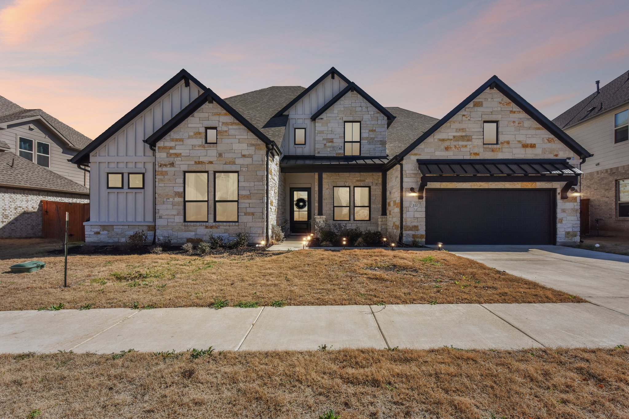 a front view of a house with a yard and garage