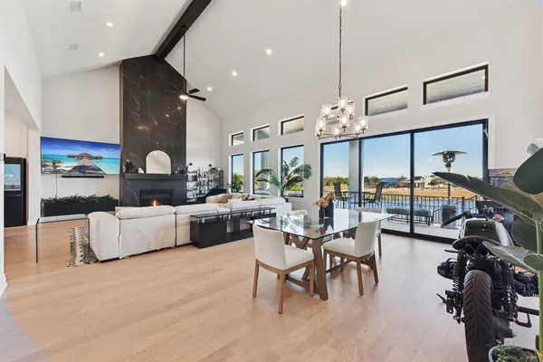a living room with fireplace furniture and a large window