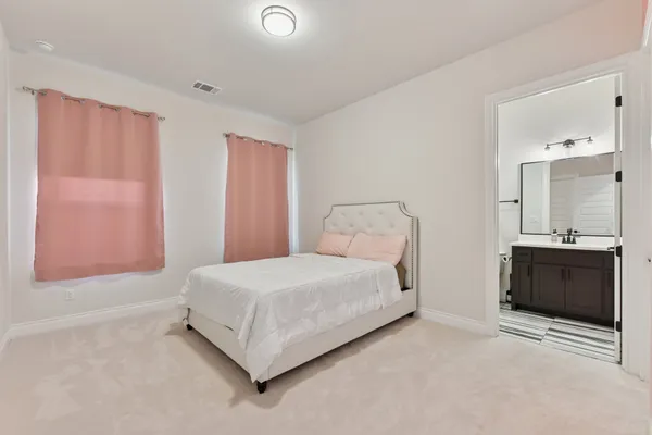 a bedroom with a bed and a dresser