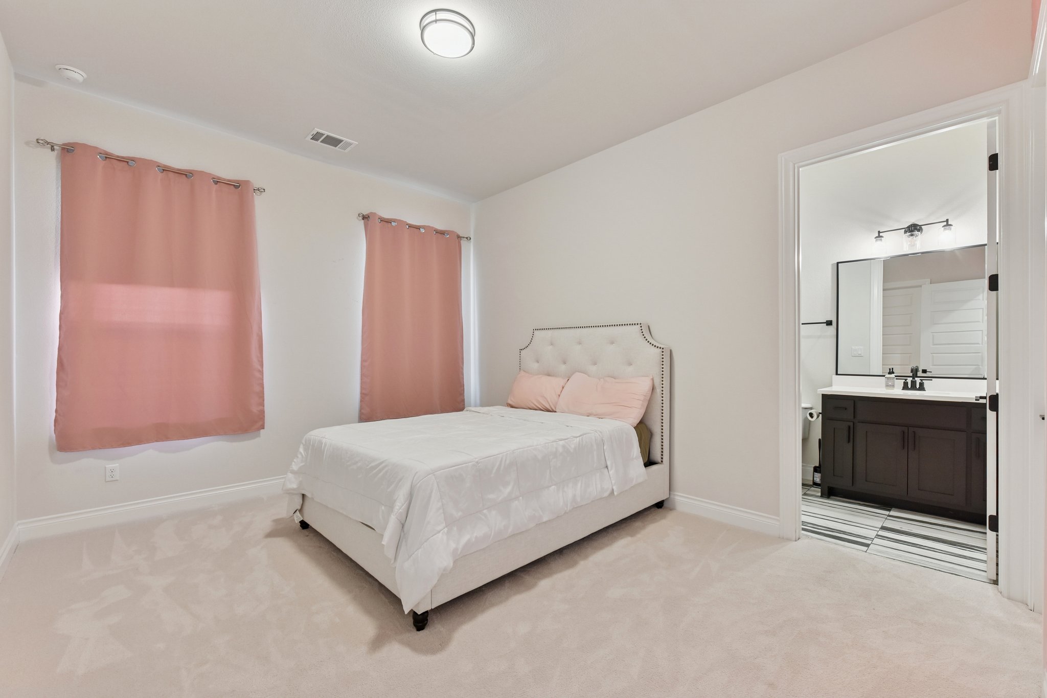 222 Rio Ranchero Road Georgetown, TX 78628 - Photo 16 of 40 a bedroom with a bed and a dresser