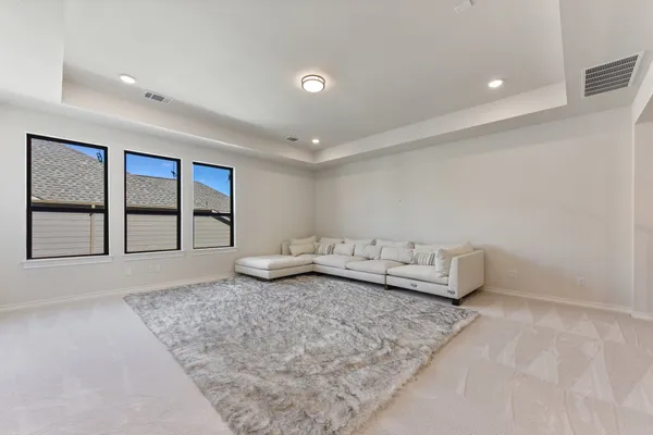 a living room with furniture and large window