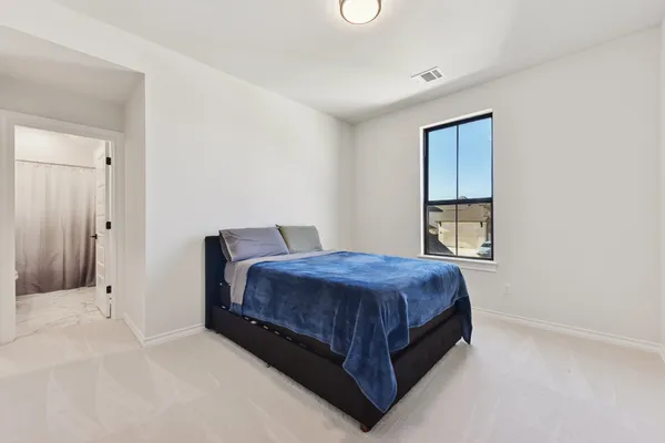 a bedroom with a bed and window