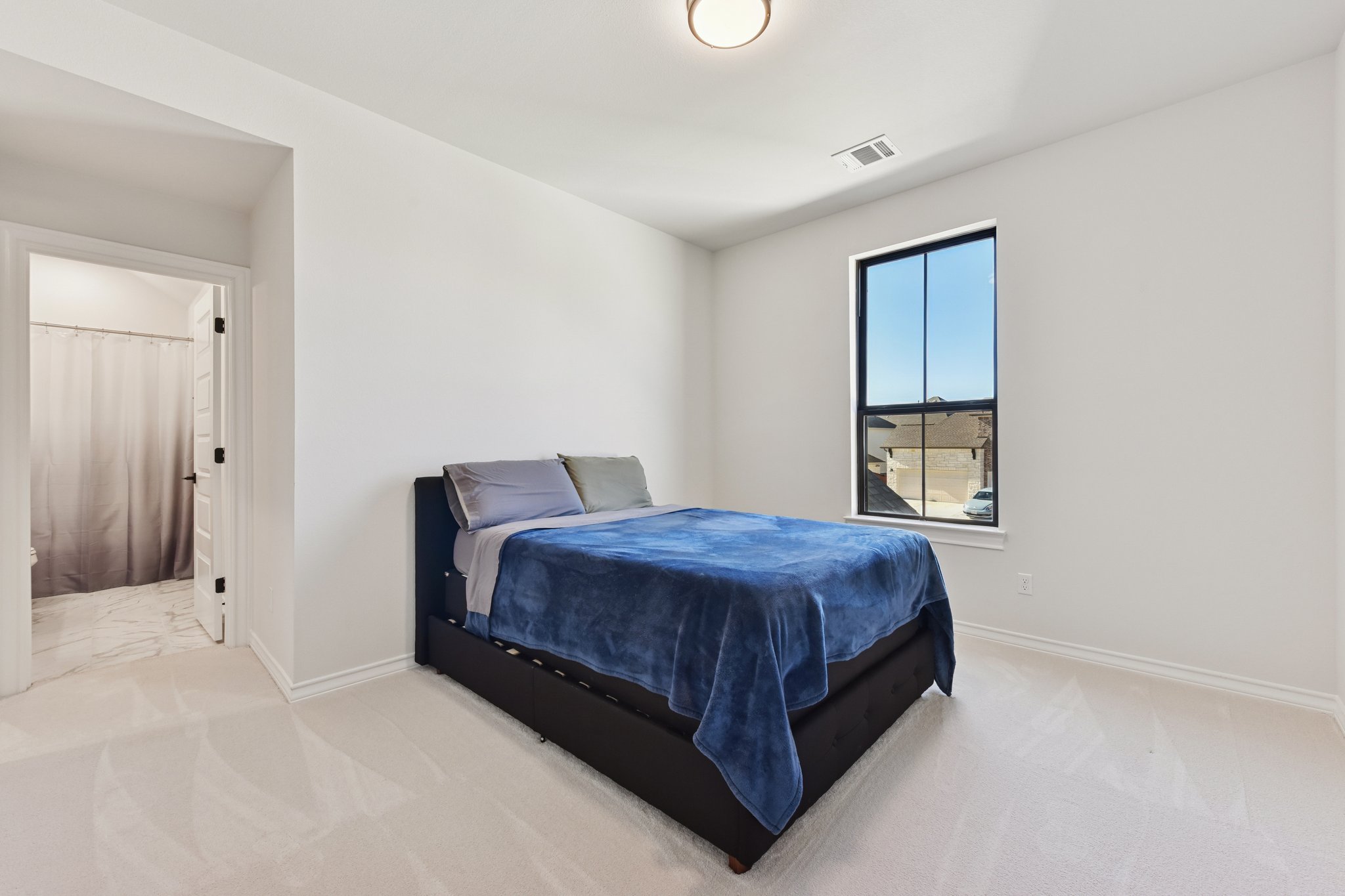 222 Rio Ranchero Road Georgetown, TX 78628 - Photo 20 of 40 a bedroom with a bed and window