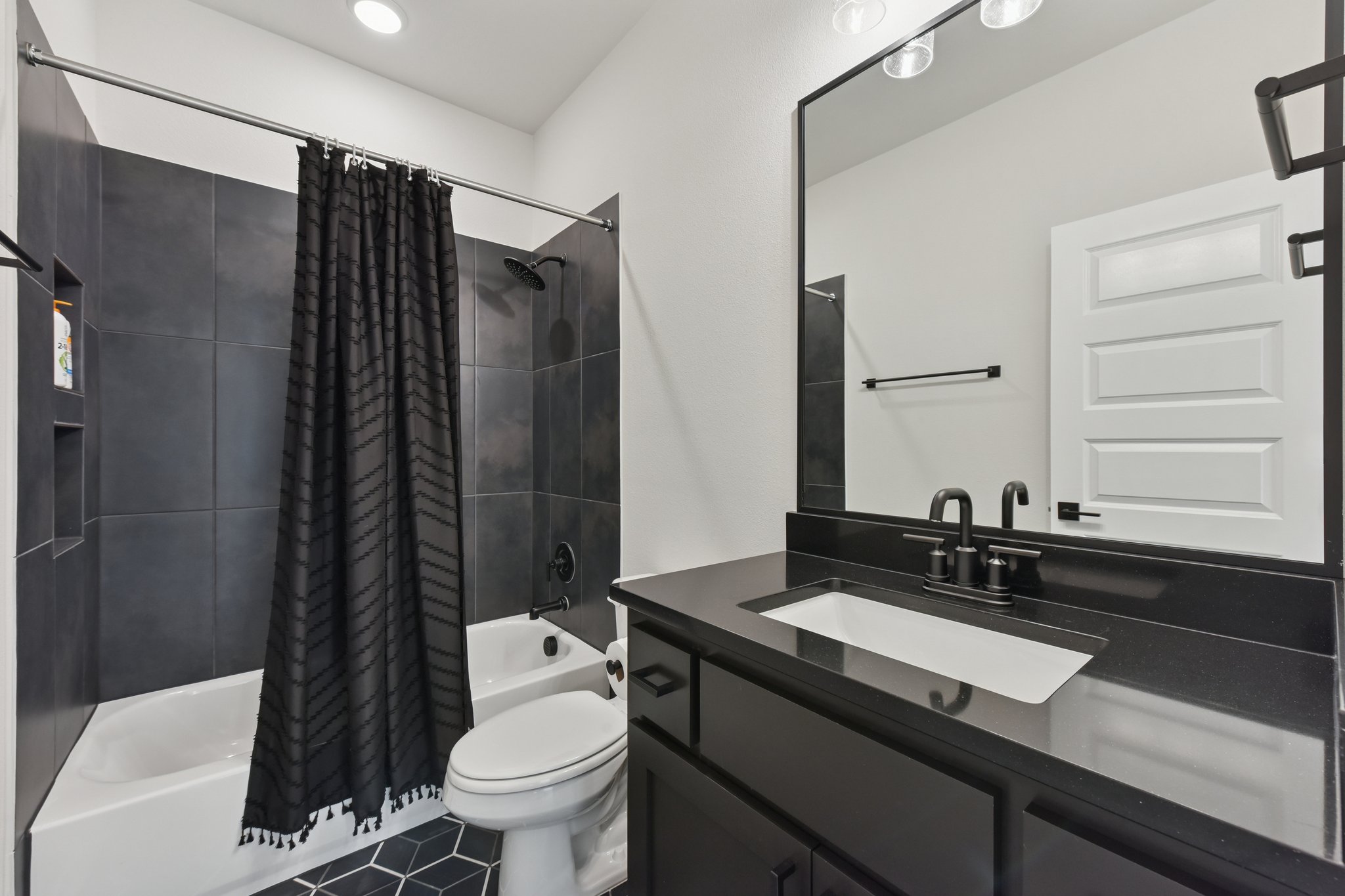 222 Rio Ranchero Road Georgetown, TX 78628 - Photo 22 of 40 a bathroom with a sink a toilet a mirror and shower