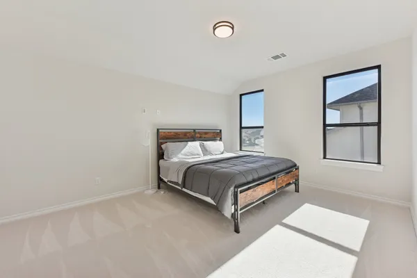 a bedroom with a bed and window