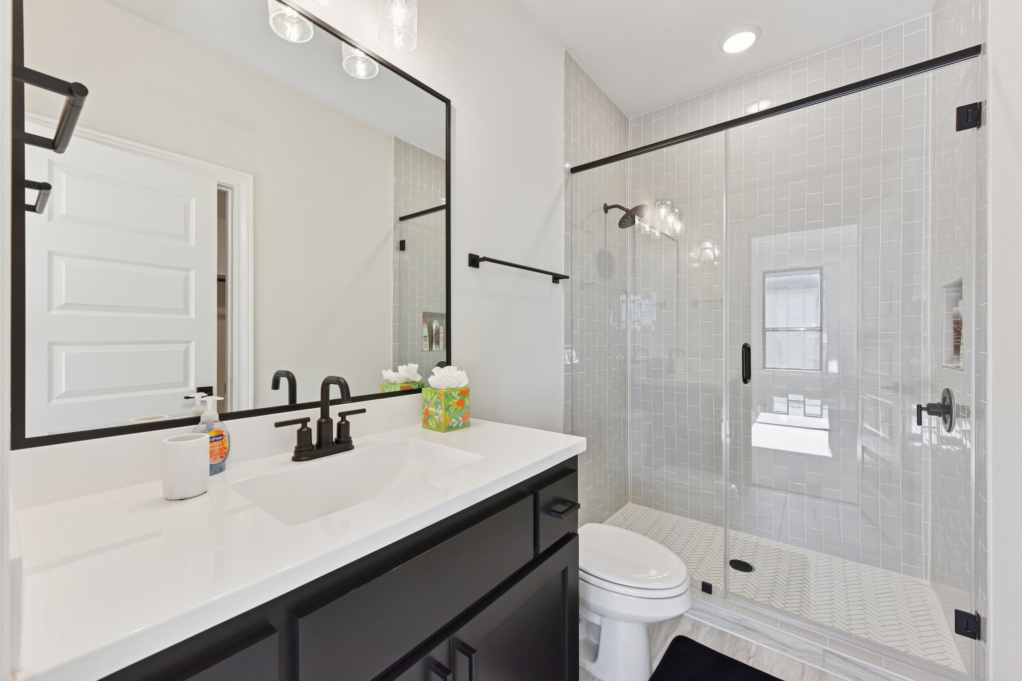 222 Rio Ranchero Road Georgetown, TX 78628 - Photo 24 of 40 a bathroom with a sink a toilet a mirror and shower