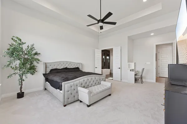 a bedroom with a bed and a potted plant