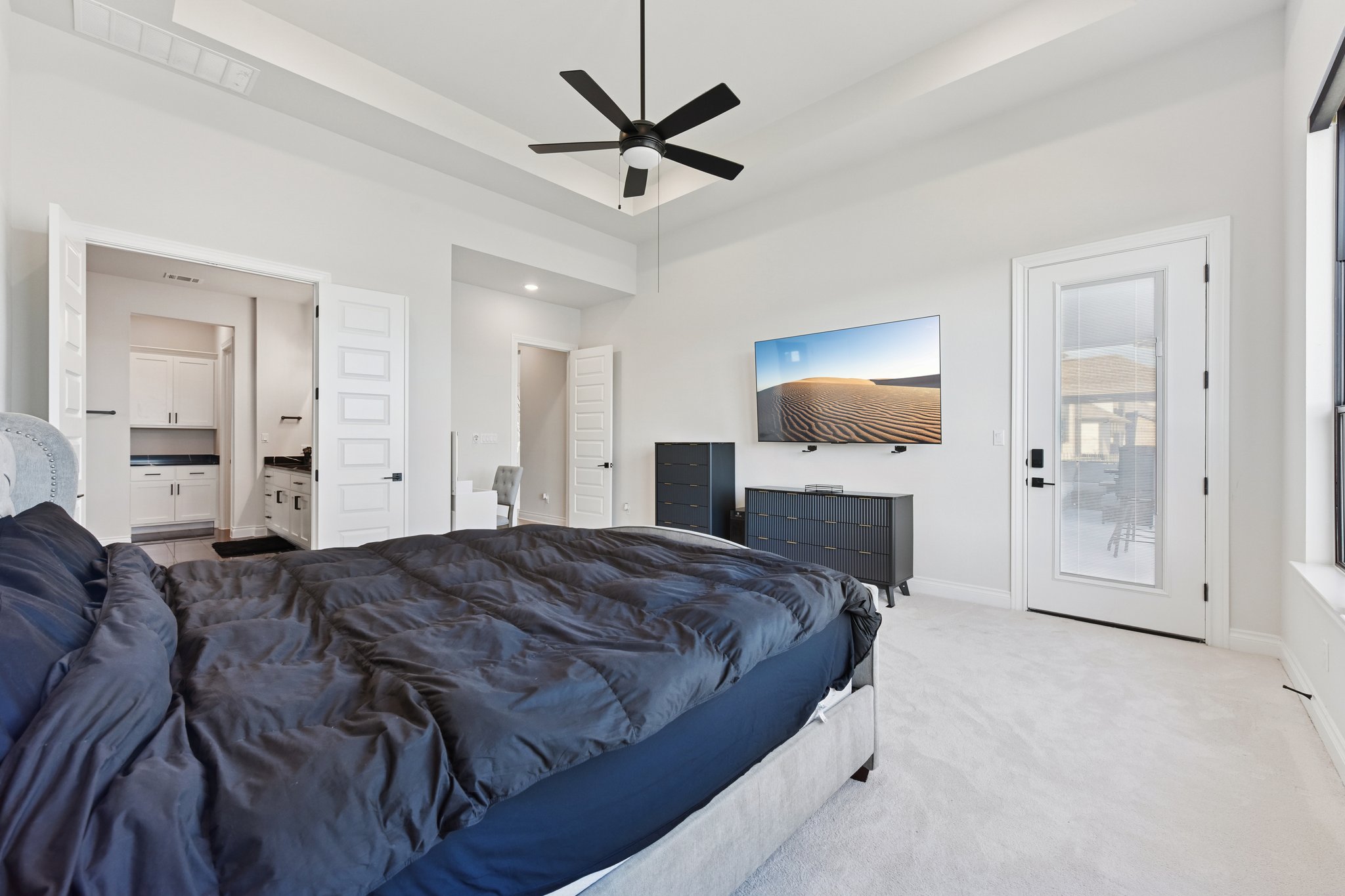 222 Rio Ranchero Road Georgetown, TX 78628 - Photo 27 of 40 a spacious bedroom with a bed and a chandelier