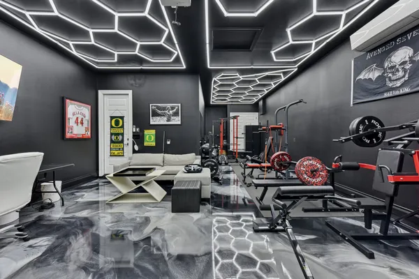 a living room with lots of furniture and with equipment